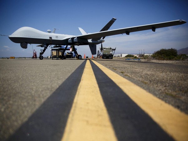 a general atomics mq 9 reaper stands on the runway during "black dart", a live fly, live fire demonstration of 55 unmanned aerial vehicles, or drones, at naval base ventura county sea range, point mugu, near oxnard, california